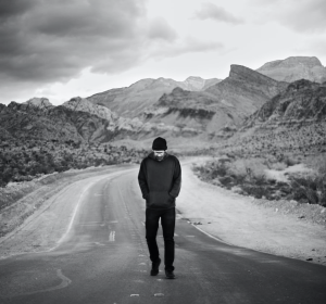 man walking down a mountain road